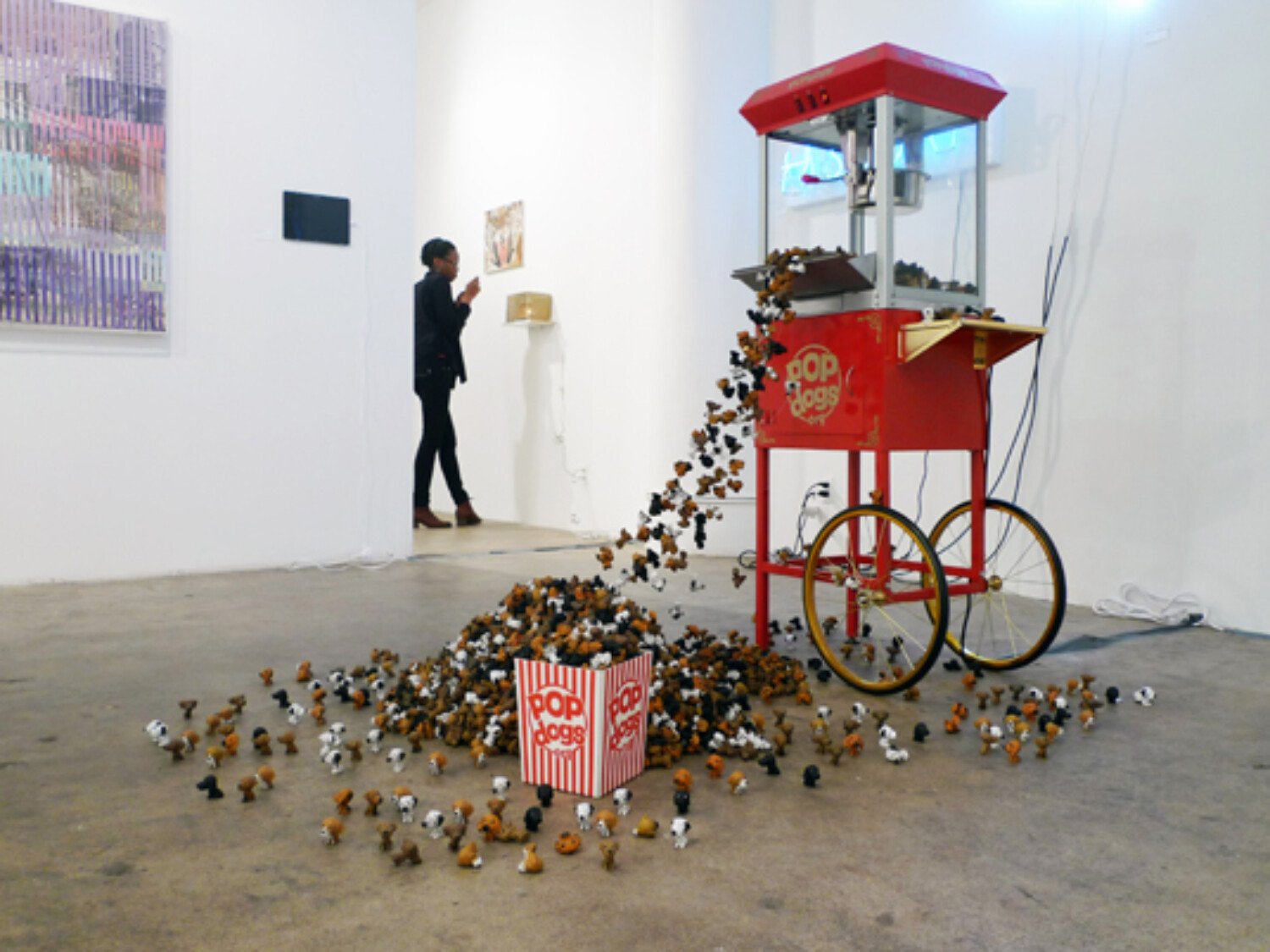 A machine with a lot of small PopDogs falling from it. Carlo Sampietro