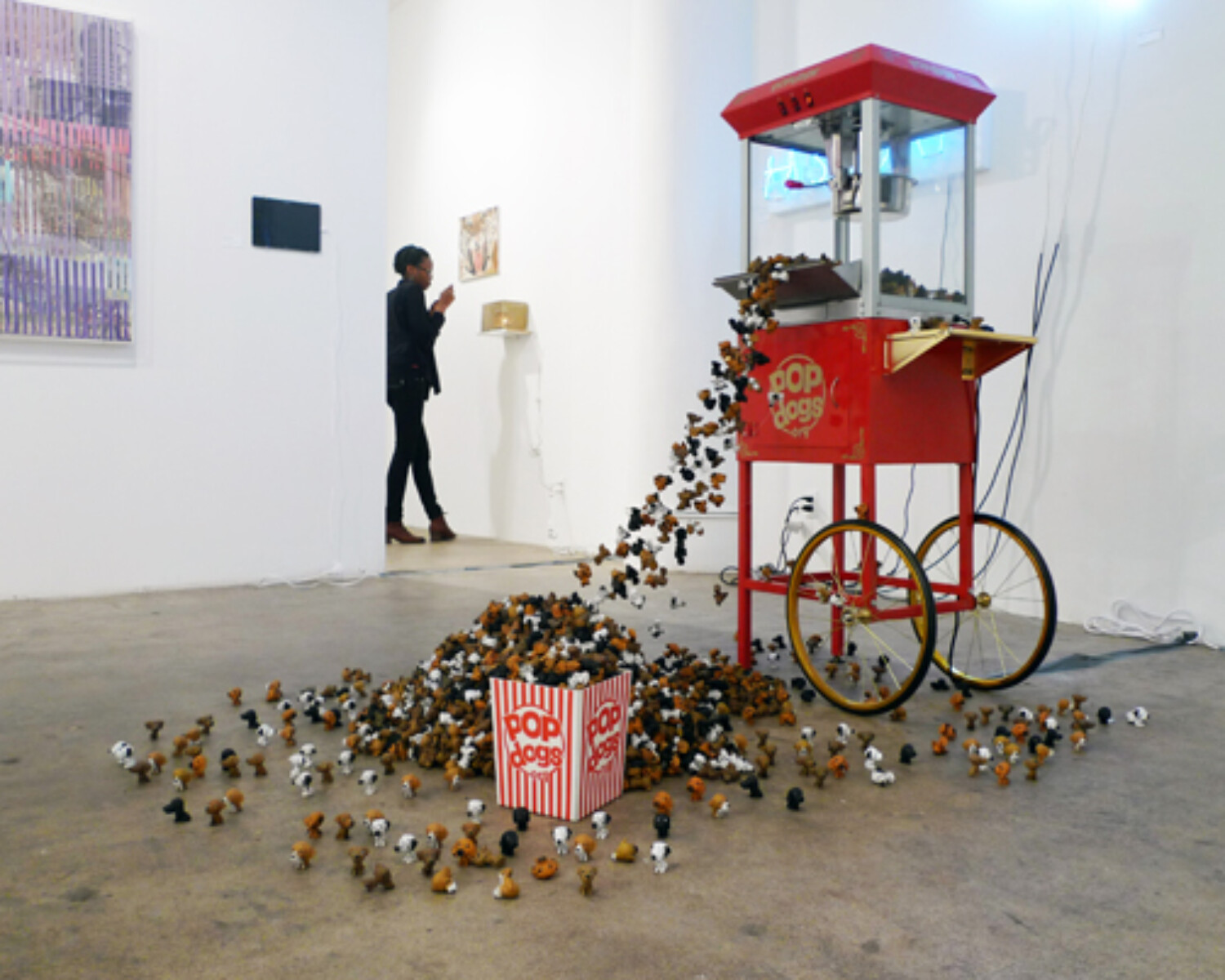 A machine with a lot of small PopDogs falling from it. Carlo Sampietro