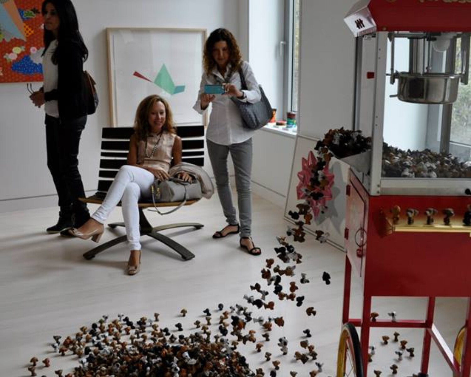 A machine with a lot of small popdogs falling from it. Carlo Sampietro