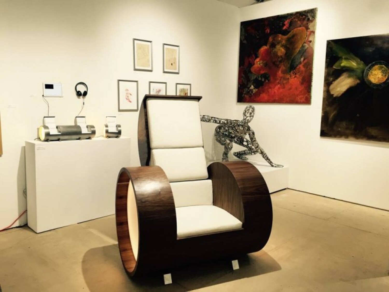 a chair in a room with art and pictures. Carlo Sampietro