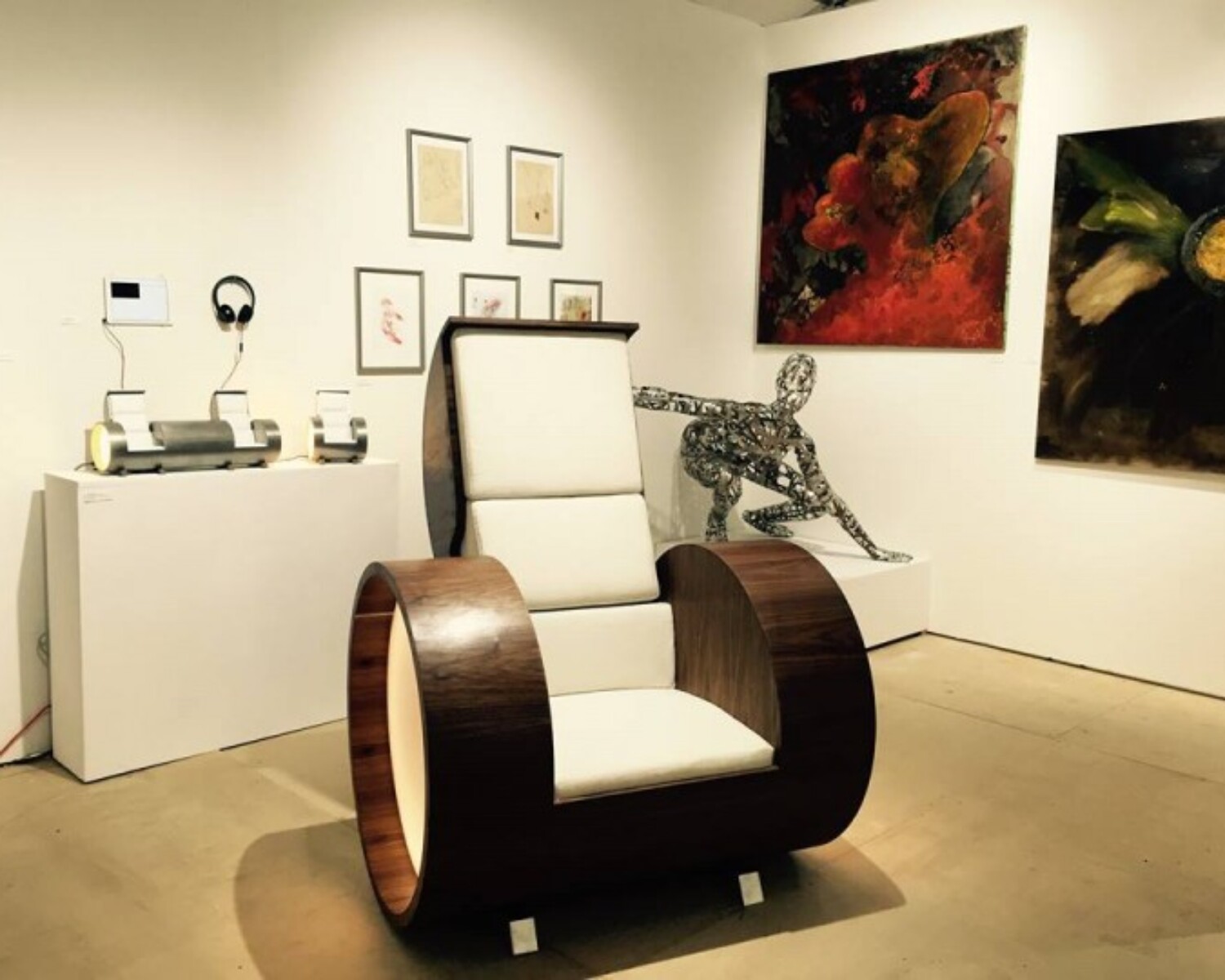 a chair in a room with art and pictures. Carlo Sampietro