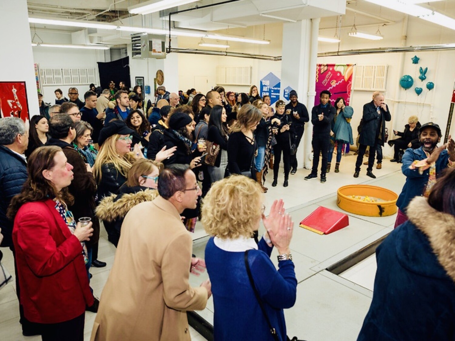 a group of people standing in a room.