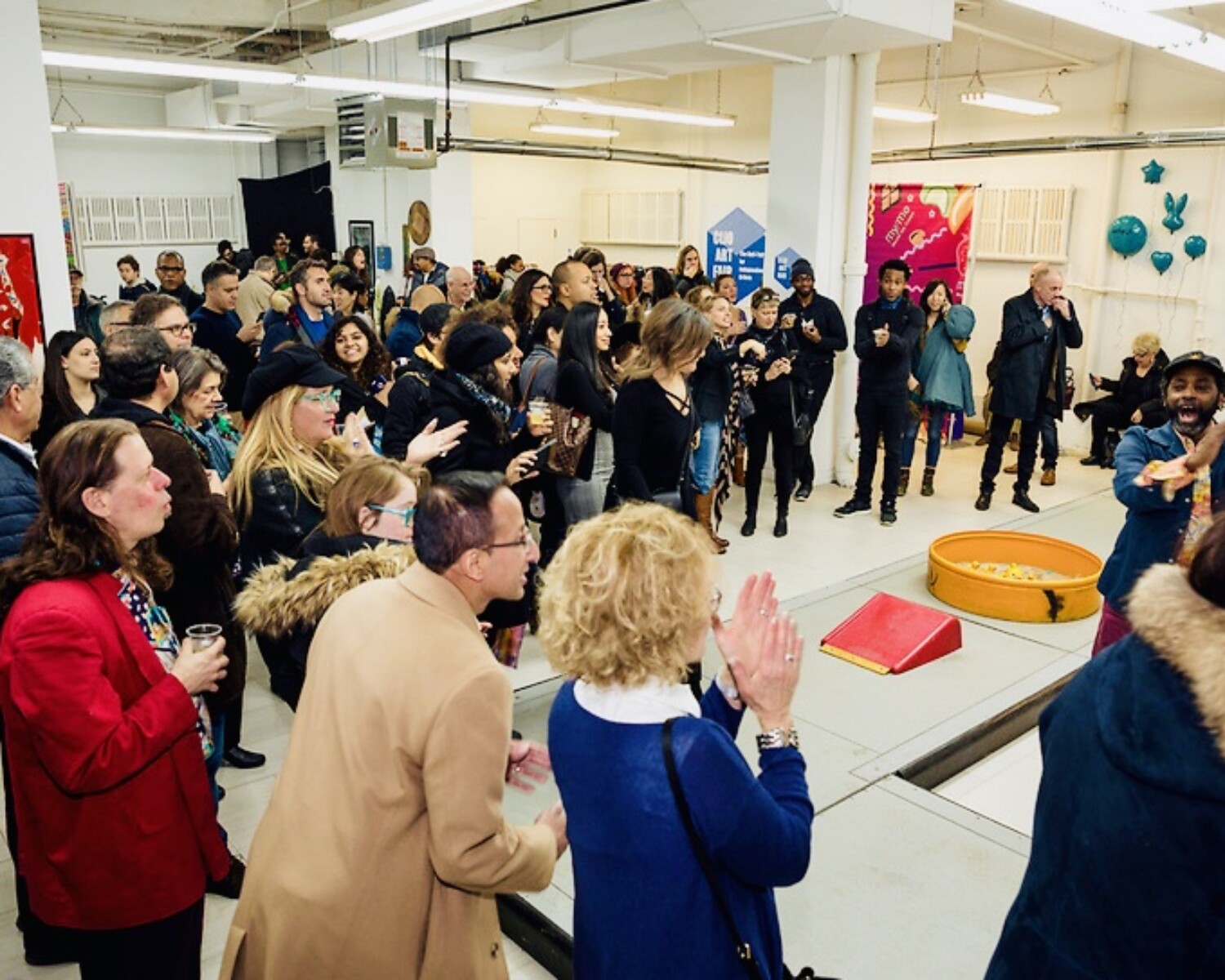 a group of people standing in a room.