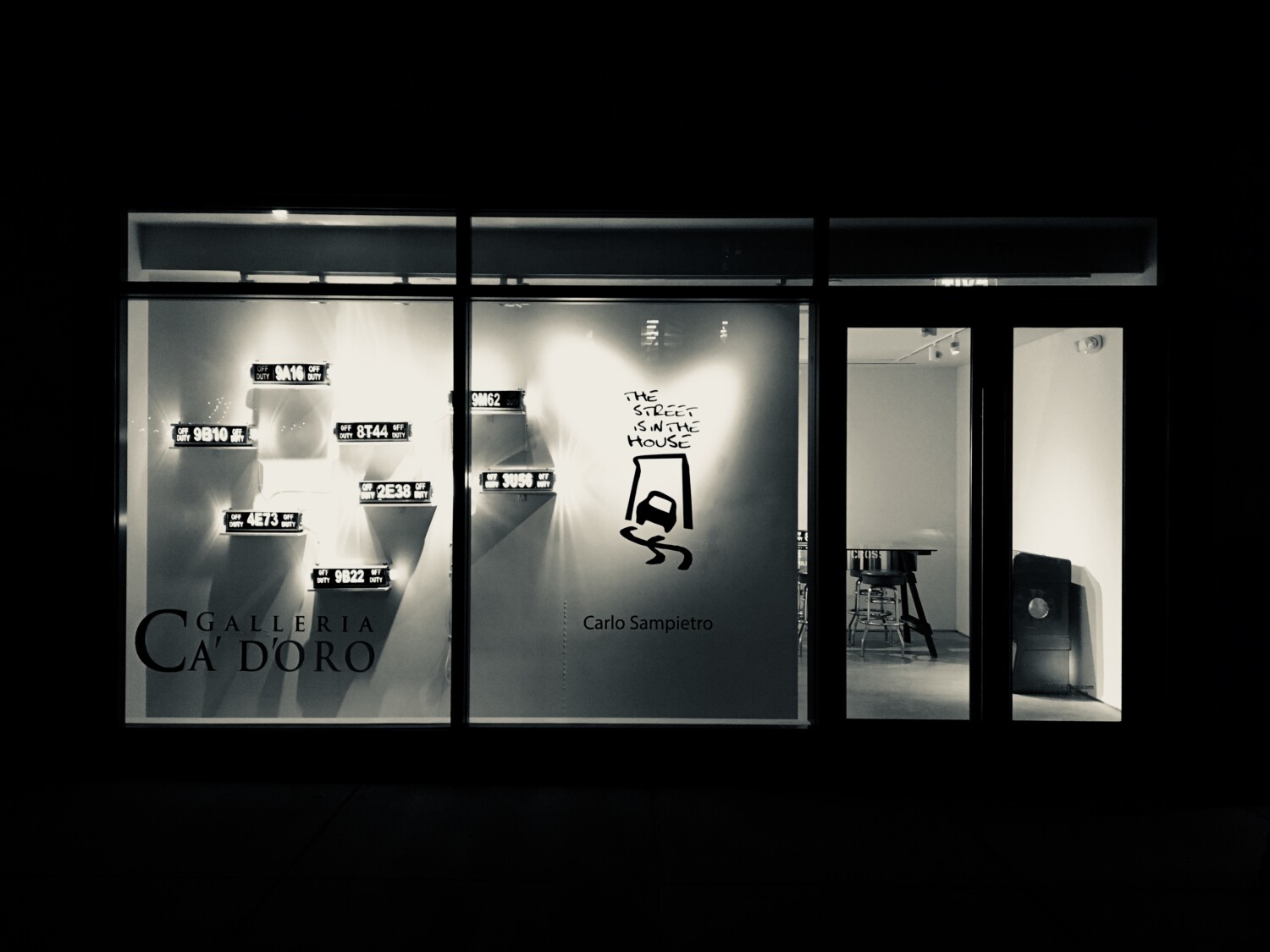 a storefront with a sign on the window.