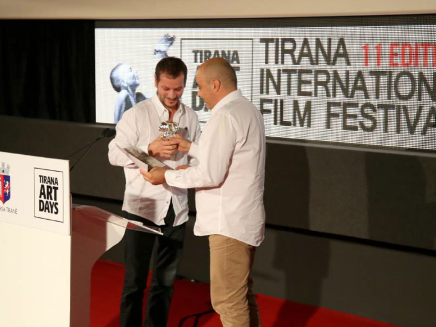 a man holding a trophy. Carlo Sampietro
