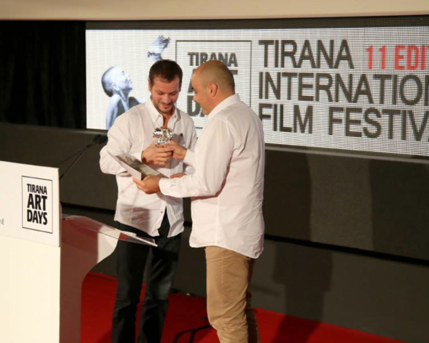 a man holding a trophy. Carlo Sampietro