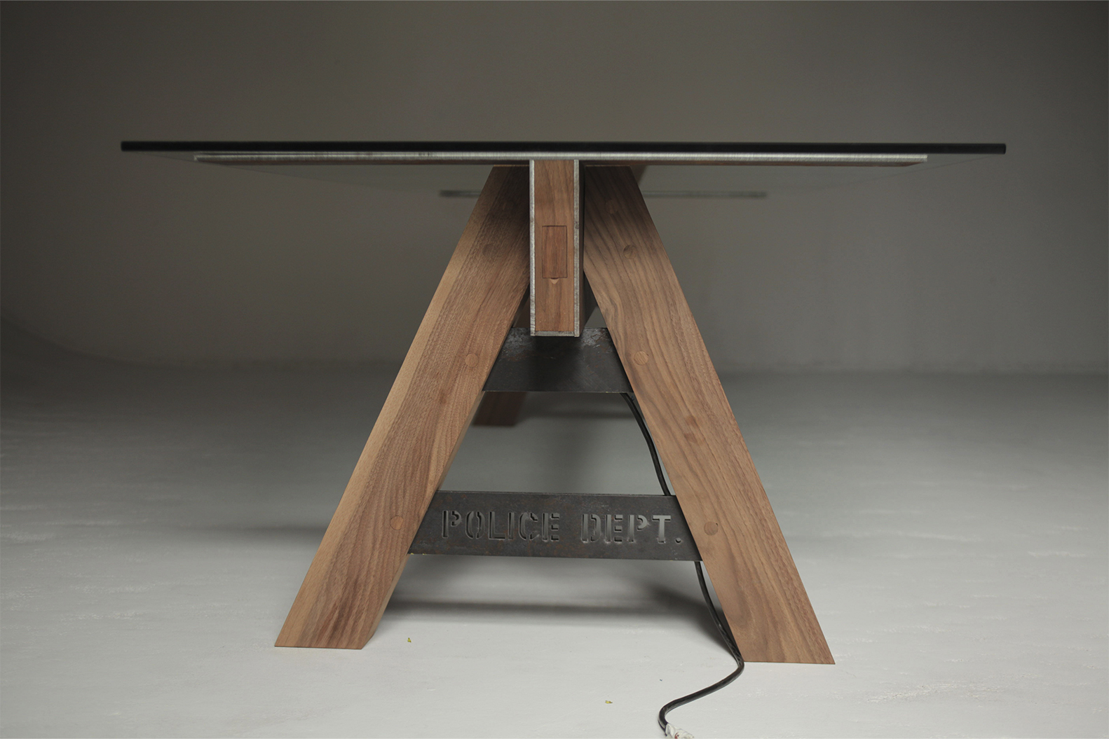 a table with a wooden base. Carlo Sampietro